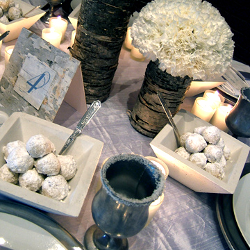 The complete table top look with pewter charger plates and mugs that are available as a rental item.
